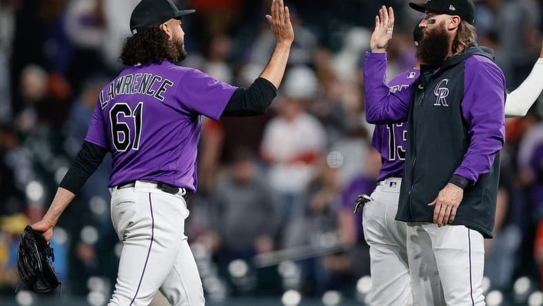 Apr 10, 2023; Denver, Colorado, USA; Colorado Rockies relief pitcher Justin Lawrence (61) reacts with designated hitter Charlie Blackmon (19) after the game against the St. Louis Cardinals at Coors Field. Mandatory Credit: Isaiah J. Downing-USA TODAY Sports