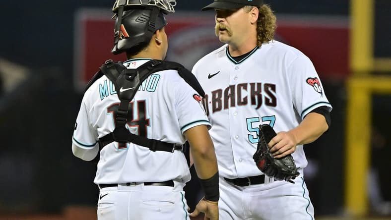 Apr 10, 2023; Phoenix, Arizona, USA; Arizona Diamondbacks relief pitcher Andrew Chafin (57) celebrates with catcher Gabriel Moreno (14) after beating the Milwaukee Brewers at Chase Field. Mandatory Credit: Matt Kartozian-USA TODAY Sports