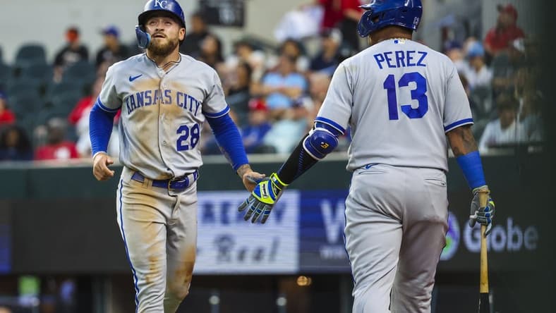 Apr 11, 2023; Arlington, Texas, USA;  Kansas City Royals center fielder Kyle Isbel (28) celebrates with Kansas City Royals catcher Salvador Perez (13) after scoring during the third inning against the Texas Rangers at Globe Life Field. Mandatory Credit: Kevin Jairaj-USA TODAY Sports