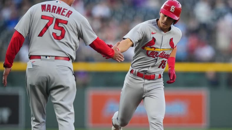 Apr 11, 2023; Denver, Colorado, USA; St. Louis Cardinals short stop Tommy Edman (19) celebrates his solo home run with third base coach Ron Warner (75) in the first inning against the Colorado Rockies at Coors Field. Mandatory Credit: Ron Chenoy-USA TODAY Sports