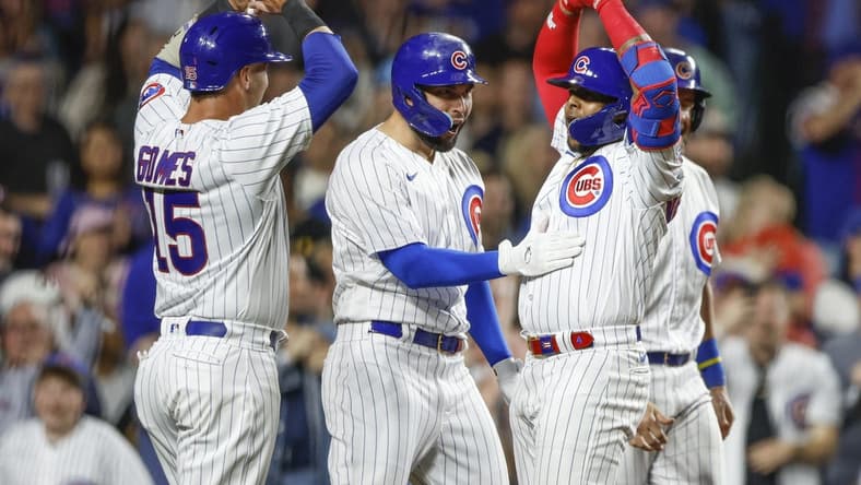 Apr 11, 2023; Chicago, Illinois, USA; Chicago Cubs center fielder Nelson Velazquez (right) celebrates with teammates as he crosses home plate after hitting a grand slam against the Seattle Mariners during the third inning at Wrigley Field. Mandatory Credit: Kamil Krzaczynski-USA TODAY Sports
