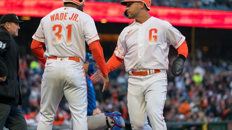 Apr 11, 2023; San Francisco, California, USA;  San Francisco Giants first baseman LaMonte Wade Jr. (31) and San Francisco Giants right fielder Michael Conforto (8) celebrate after the score against the Los Angeles Dodgers during the first inning at Oracle Park. Mandatory Credit: Neville E. Guard-USA TODAY Sports