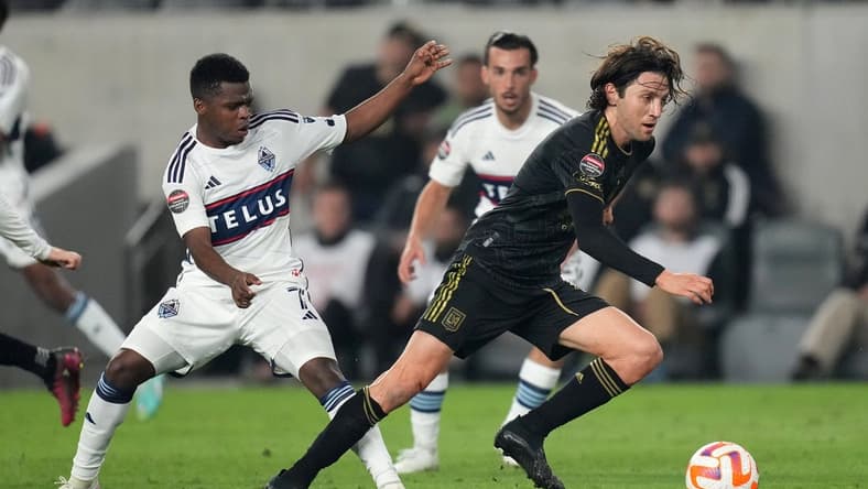 Apr 11, 2023; Los Angeles, CA, USA; LAFC midfielder Ilie Sanchez (6) and Vancouver Whitecaps forward Deiber Caicedo (7) battle for the ball in the first half at BMO Stadium. Mandatory Credit: Kirby Lee-USA TODAY Sports
