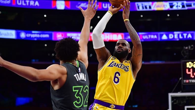 Apr 11, 2023; Los Angeles, California, USA; Los Angeles Lakers forward LeBron James (6) shoots against Minnesota Timberwolves center Karl-Anthony Towns (32) during the first half at Crypto.com Arena. Mandatory Credit: Gary A. Vasquez-USA TODAY Sports