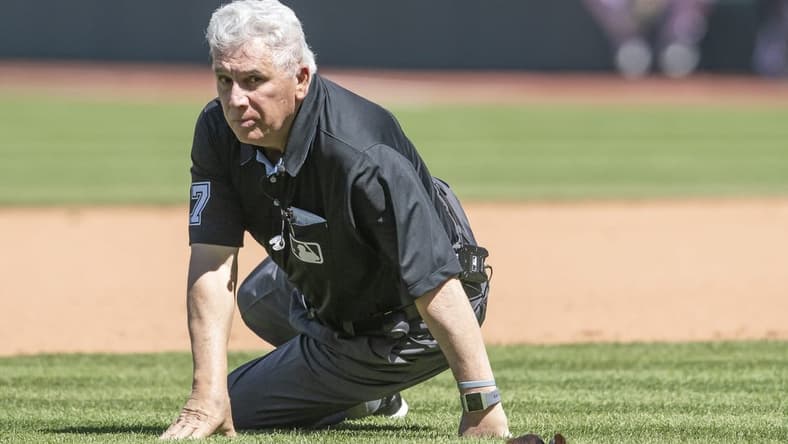 Apr 12, 2023; Cleveland, Ohio, USA; Umpire Larry Vanover (27) gets up after being hit with the baseball during a play in the fifth inning of the game between the Cleveland Guardians and the New York Yankees at Progressive Field. Mandatory Credit: Ken Blaze-USA TODAY Sports
