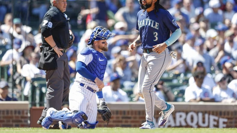 Apr 12, 2023; Chicago, Illinois, USA; Seattle Mariners shortstop J.P. Crawford (3) scores against the Chicago Cubs during the third inning at Wrigley Field. Mandatory Credit: Kamil Krzaczynski-USA TODAY Sports