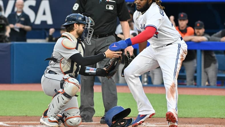 Apr 12, 2023; Toronto, Ontario, CAN;  Toronto Blue Jays first baseman Vladimir Guerrero Jr. (27) is tagged out at home by Detrot Tigers catcher Eric Haase (13) in the first inning at Rogers Centre. Mandatory Credit: Dan Hamilton-USA TODAY Sports