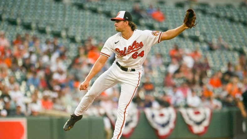 Apr 12, 2023; Baltimore, Maryland, USA;  Baltimore Orioles starting pitcher Dean Kremer (64) throws a first inning pitch against the Oakland Athletics at Oriole Park at Camden Yards. Mandatory Credit: Tommy Gilligan-USA TODAY Sports