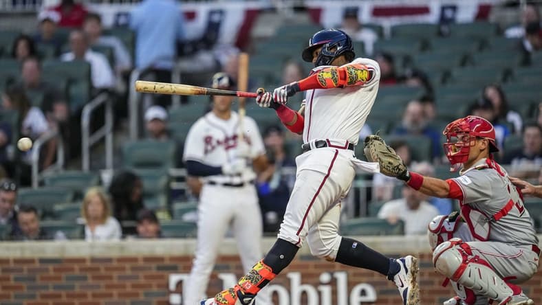 Apr 12, 2023; Cumberland, Georgia, USA; Atlanta Braves right fielder Ronald Acuna Jr. (13) singles to drive in two runs against the Cincinnati Reds during the second inning at Truist Park. Mandatory Credit: Dale Zanine-USA TODAY Sports