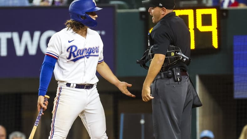 Apr 12, 2023; Arlington, Texas, USA;  Texas Rangers shortstop Josh Smith (47) argues with umpire Jansen Visconti (52) after striking out during the ninth inning at Globe Life Field. Mandatory Credit: Kevin Jairaj-USA TODAY Sports