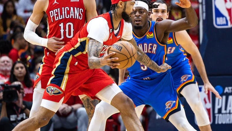 Apr 12, 2023; New Orleans, Louisiana, USA; New Orleans Pelicans forward Brandon Ingram (14) dribbles against Oklahoma City Thunder guard Luguentz Dort (5) during the first half at Smoothie King Center. Mandatory Credit: Stephen Lew-USA TODAY Sports