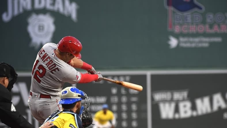 Apr 14, 2023; Boston, Massachusetts, USA; Los Angeles Angels right fielder Hunter Renfroe (12) hits an RBI double during the first inning against the Boston Red Sox at Fenway Park. Mandatory Credit: Bob DeChiara-USA TODAY Sports