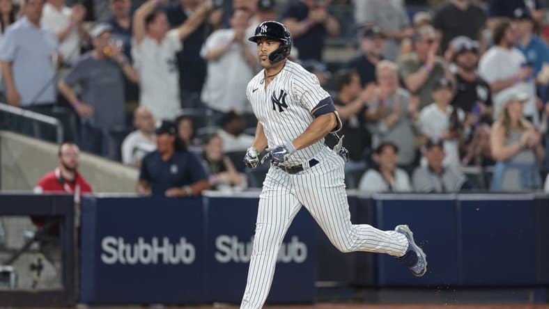 Apr 14, 2023; Bronx, New York, USA; New York Yankees right fielder Giancarlo Stanton (27) runs the base path after hitting a solo home run during the sixth inning against the Minnesota Twins at Yankee Stadium. Mandatory Credit: Vincent Carchietta-USA TODAY Sports