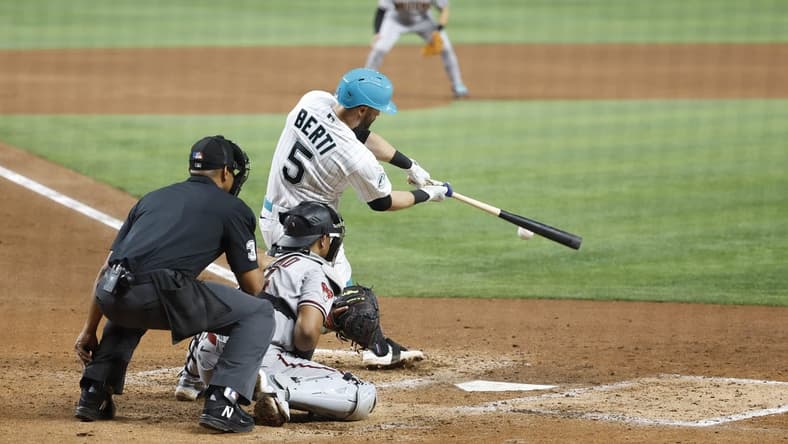 Apr 14, 2023; Miami, Florida, USA; Miami Marlins third baseman Jon Berti (5) doubles against the Arizona Diamondbacks during the fifth inning at loanDepot Park. Mandatory Credit: Rhona Wise-USA TODAY Sports