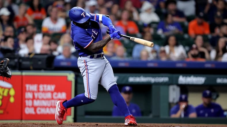 Apr 14, 2023; Houston, Texas, USA; Texas Rangers right fielder Adolis Garcia (53) hits a two-run home run to center field against the Houston Astros during the third inning at Minute Maid Park. Mandatory Credit: Erik Williams-USA TODAY Sports