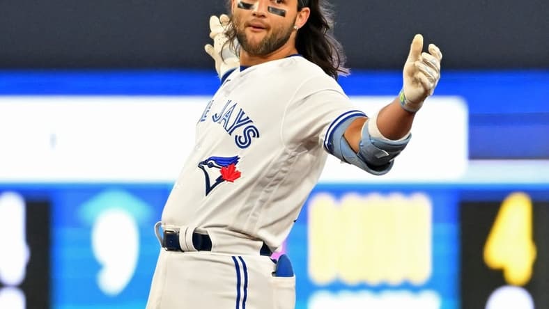 Apr 14, 2023; Toronto, Ontario, CAN;    Toronto Blue Jays shortstop Bo Bichette (11) reacts after hitting a double against the Tampa Bay Rays in the eighth inning at Rogers Centre. Mandatory Credit: Dan Hamilton-USA TODAY Sports