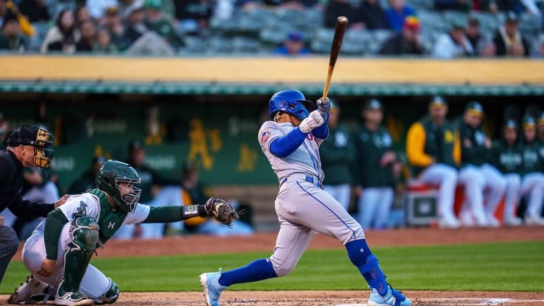 Apr 14, 2023; Oakland, California, USA;  New York Mets shortstop Francisco Lindor (12) hits a grand slam home run against the Oakland Athletics during the second inning at RingCentral Coliseum. Mandatory Credit: Neville E. Guard-USA TODAY Sports