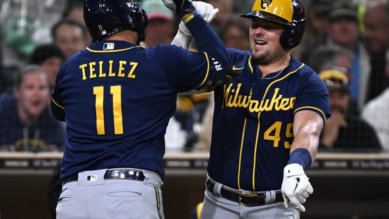 Apr 14, 2023; San Diego, California, USA; Milwaukee Brewers first baseman hitter Rowdy Tellez (11) is congratulated by designated hitter Luke Voit (45) after hitting a home run against the San Diego Padres during the fourth inning at Petco Park. Mandatory Credit: Orlando Ramirez-USA TODAY Sports