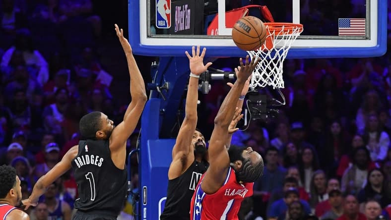 Apr 15, 2023; Philadelphia, Pennsylvania, USA; Philadelphia 76ers guard James Harden (1) reaches for ball  forward Mikal Bridges (1) during the first quarter of game one of the 2023 NBA playoffs at Wells Fargo Center. Mandatory Credit: Eric Hartline-USA TODAY Sports