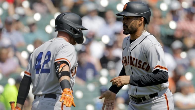 Apr 15, 2023; Detroit, Michigan, USA;  San Francisco Giants first baseman LaMonte Wade Jr. (right) celebrates with fielder Matt Beaty (left) after scoring against the Detroit Tigers in the first inning at Comerica Park. Mandatory Credit: Rick Osentoski-USA TODAY Sports