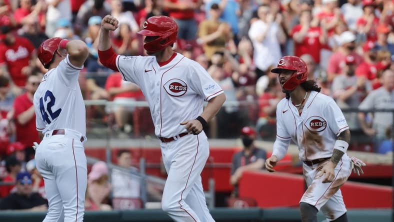 Apr 15, 2023; Cincinnati, Ohio, USA; Cincinnati Reds first baseman Wil Myers (middle) reacts with third baseman Spencer Steer (left) and second baseman Jonathan India (right) after hitting a three-run home run against the Philadelphia Phillies during the third inning at Great American Ball Park. Mandatory Credit: David Kohl-USA TODAY Sports