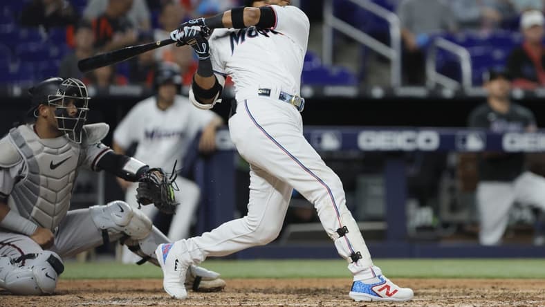 Apr 15, 2023; Miami, Florida, USA; Miami Marlins second baseman Luis Arraez (42) hits an RBI single during the seventh inning against the Arizona Diamondbacks at loanDepot Park. Mandatory Credit: Sam Navarro-USA TODAY Sports