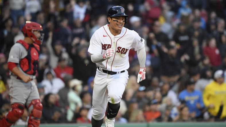 Apr 15, 2023; Boston, Massachusetts, USA; Boston Red Sox catcher Connor Wong (12) runs to first after hitting an RBI single during the eighth inning against the Los Angeles Angels at Fenway Park. Mandatory Credit: Bob DeChiara-USA TODAY Sports