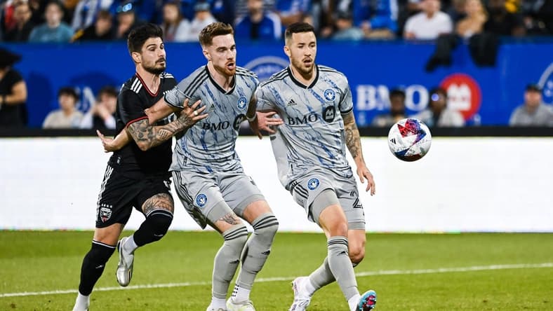 Apr 15, 2023; Montreal, Quebec, CAN; CF Montreal defender Joel Waterman (16) and defender Aaron Herrera (22) defend the ball against DC United forward Taxi Fountas (11) during the first half at Stade Saputo. Mandatory Credit: David Kirouac-USA TODAY Sports
