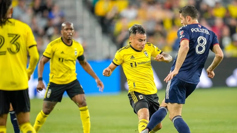Apr 15, 2023; Columbus, Ohio, United States;  New England Revolution midfielder Matt Polster (8) kicks the ball away from Columbus Crew midfielder Lucas Zelarayan (10) during the first half of the MLS soccer game between Columbus Crew and New England Revolution at Lower.com Field on Saturday evening. Mandatory Credit: Joseph Scheller-The Columbus Dispatch

Mls Ceb Crew New England New England At Crew