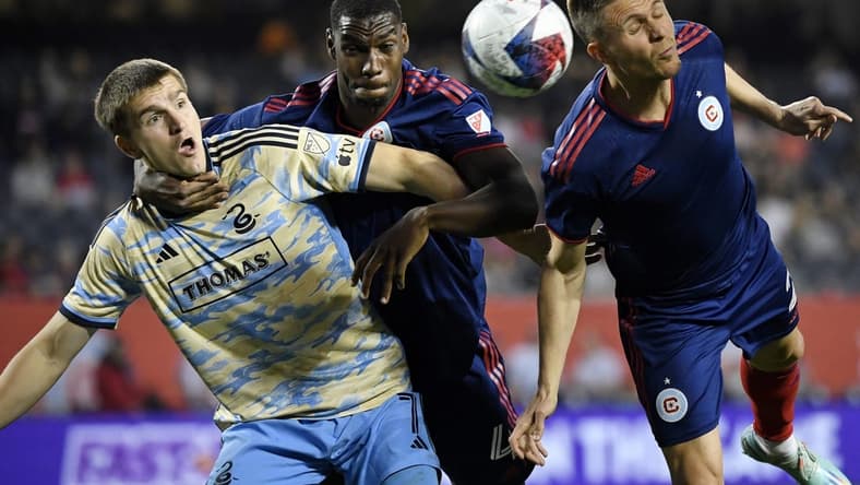 Apr 15, 2023; Chicago, Illinois, USA; Philadelphia Union forward Mikael Uhre (7) battles for a header against Chicago Fire defender Carlos Teran (4) and defender Arnaud Souquet (right) during the first half at Soldier Field. Mandatory Credit: Jon Durr-USA TODAY Sports