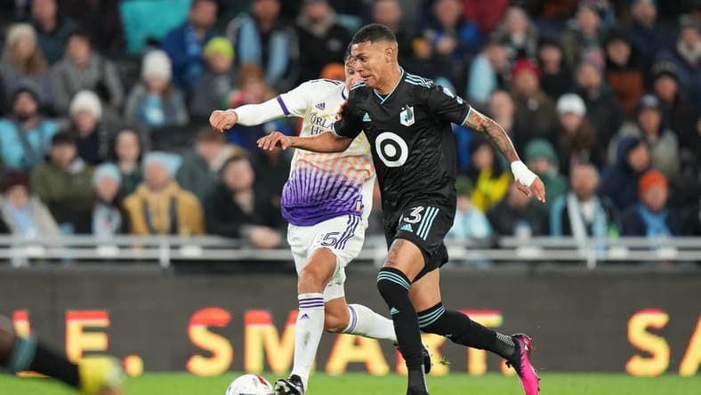 Apr 15, 2023; Saint Paul, Minnesota, USA; Minnesota United FC midfielder Kervin Arriaga (33) dribbles the ball as Orlando City SC defender Rodrigo Schlegel (15) chases during the first half at Allianz Field. Mandatory Credit: Brace Hemmelgarn-USA TODAY Sports