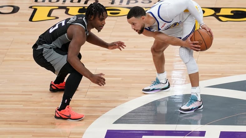 Apr 15, 2023; Sacramento, California, USA; Golden State Warriors guard Stephen Curry (30) holds onto the ball next to Sacramento Kings guard Davion Mitchell (15) in the second quarter during game one of the 2023 NBA playoffs at the Golden 1 Center. Mandatory Credit: Cary Edmondson-USA TODAY Sports