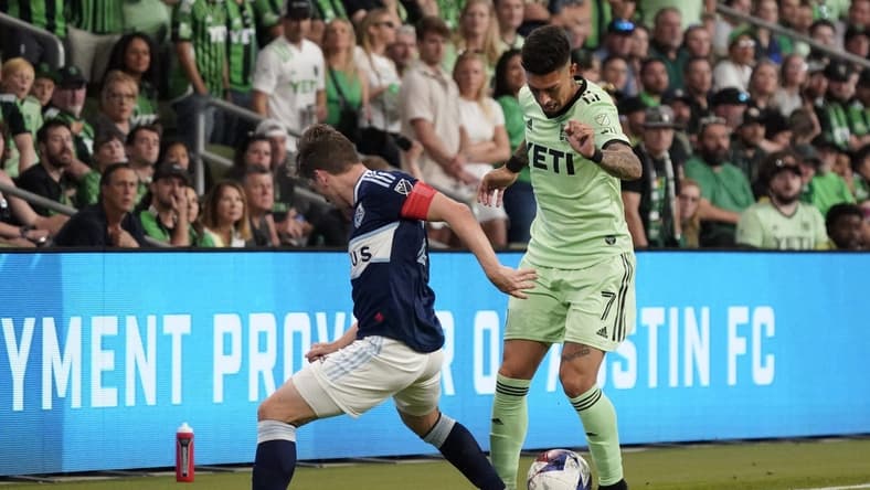 Apr 15, 2023; Austin, Texas, USA; Austin FC midfielder Emiliano Rigoni (7) fights for ball against NJ/NY Gotham FC player during the game at Q2 Stadium. Mandatory Credit: Scott Wachter-USA TODAY Sports