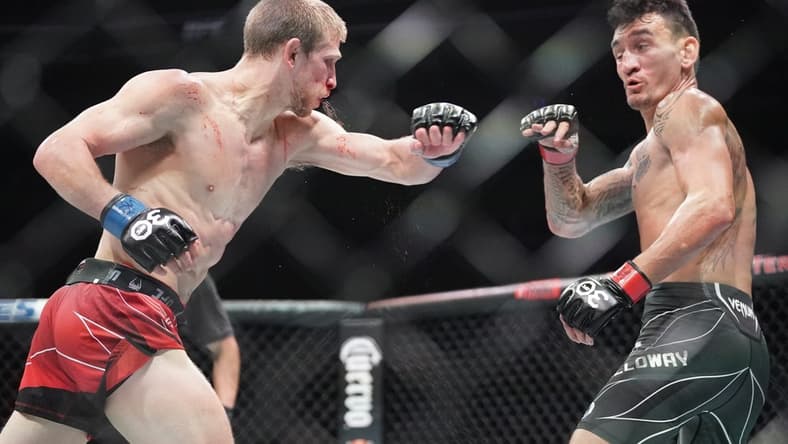 Apr 15, 2023; Kansas City, Missouri, USA; Max Holloway (red gloves) fights Arnold Allen (blue gloves) during UFC Fight Night at T-Mobile Center. Mandatory Credit: Denny Medley-USA TODAY Sports