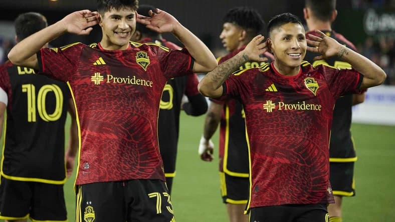 Apr 15, 2023; Portland, Oregon, USA; Seattle Sounders forward Raul Ruidiaz (9), right, celebrates scoring a goal with teammate midfielder Obed Vargas (73) during the second half against the Portland Timbers at Providence Park. Mandatory Credit: Troy Wayrynen-USA TODAY Sports