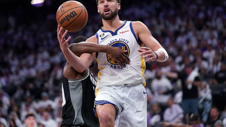 Apr 15, 2023; Sacramento, California, USA; Golden State Warriors guard Klay Thompson (11) is hit by Sacramento Kings forward Harrison Barnes (40) in the third quarter during game one of the 2023 NBA playoffs at the Golden 1 Center. Mandatory Credit: Cary Edmondson-USA TODAY Sports