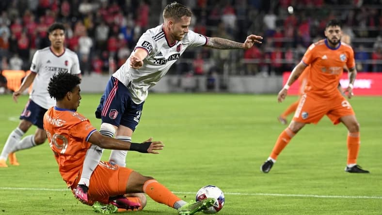 Apr 15, 2023; St. Louis, Missouri, USA; FC Cincinnati forward Arquimides Ordonez (29) and St. Louis City forward Rasmus Alm (21) battle for the ball during the first half at CITYPARK. Mandatory Credit: Scott Rovak-USA TODAY Sports