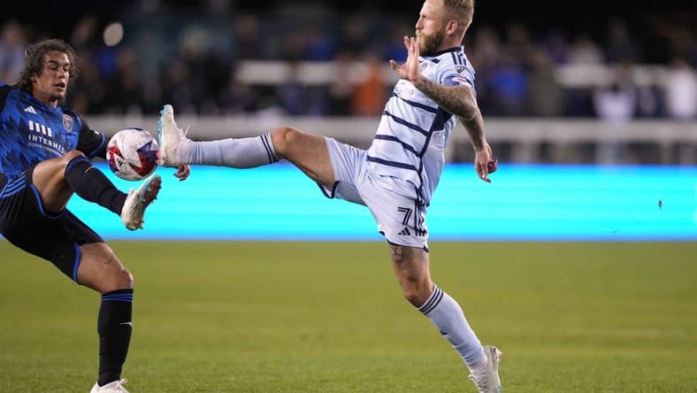Apr 15, 2023; San Jose, California, USA; Sporting Kansas City forward Johnny Russell (7) reaches for the ball against San Jose Earthquakes forward Cade Cowell (left) during the first half at PayPal Park. Mandatory Credit: Darren Yamashita-USA TODAY Sports