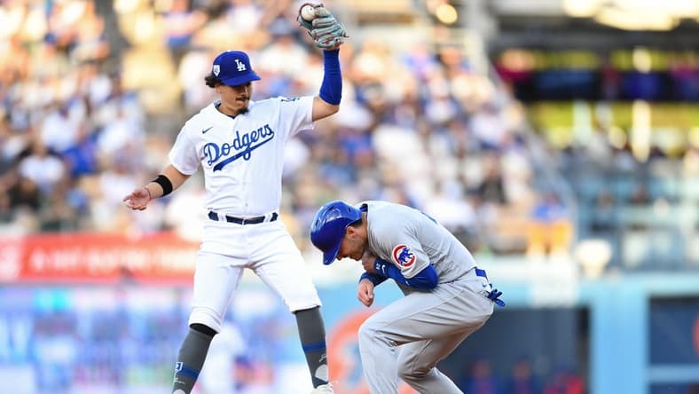 Apr 15, 2023; Los Angeles, California, USA; Chicago Cubs center fielder Cody Bellinger is safe at second base against Los Angeles Dodgers second baseman Miguel Vargas during the second inning at Dodger Stadium. Mandatory Credit: Jonathan Hui-USA TODAY Sports