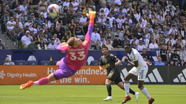 Apr 16, 2023; Carson, California, USA; Los Angeles FC forward Carlos Vela (10) scores a goal past Los Angeles Galaxy goalkeeper Jonathan Klinsmann and midfielder Memo Rodriguez (17) in the first half at Dignity Health Sports Park. Mandatory Credit: Jayne Kamin-Oncea-USA TODAY Sports
