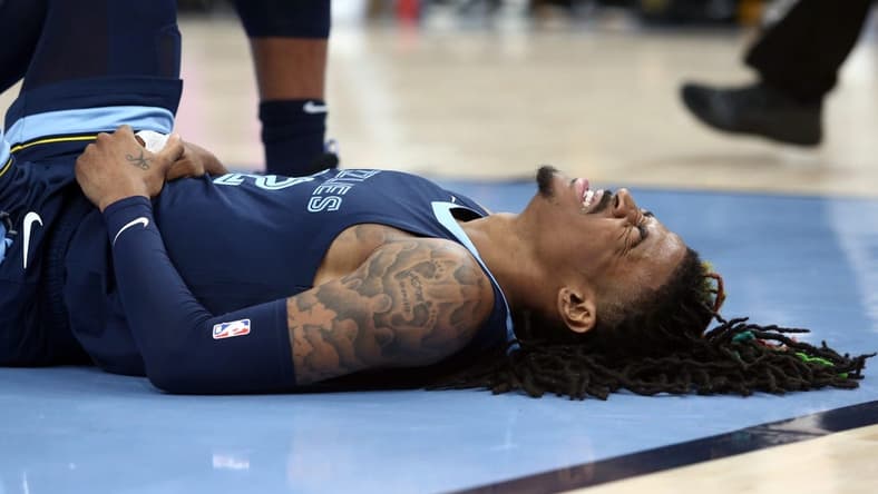 Apr 16, 2023; Memphis, Tennessee, USA; Memphis Grizzlies guard Ja Morant (12)reacts after falling to the ground during the second half during game one of the 2023 NBA playoffs against the Los Angeles Lakers at FedExForum. Mandatory Credit: Petre Thomas-USA TODAY Sports