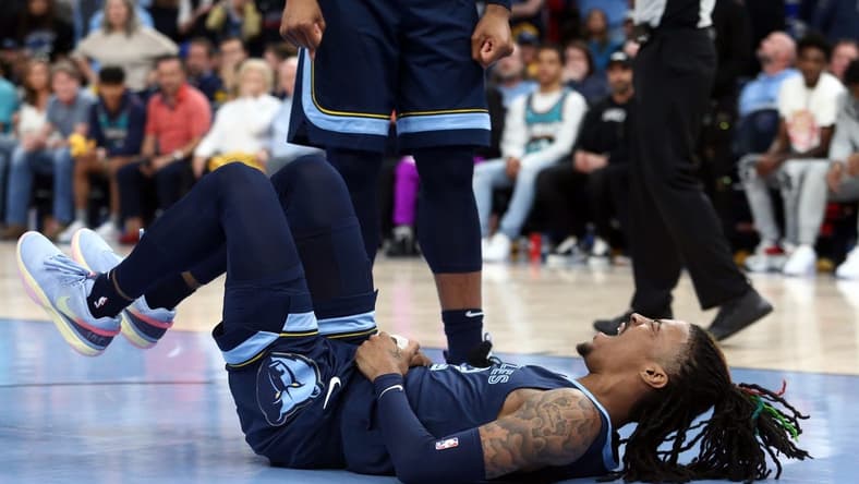 Apr 16, 2023; Memphis, Tennessee, USA; Memphis Grizzlies guard Ja Morant (12)reacts after falling to the ground during the second half during game one of the 2023 NBA playoffs against the Los Angeles Lakers at FedExForum. Mandatory Credit: Petre Thomas-USA TODAY Sports