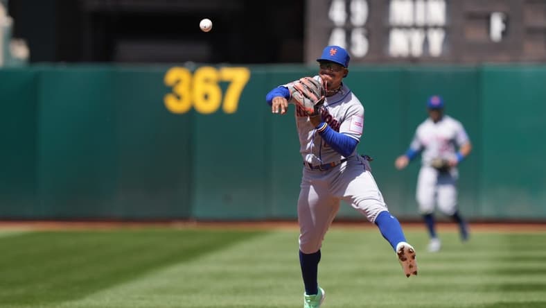 Apr 16, 2023; Oakland, California, USA; New York Mets shortstop Francisco Lindor (12) throws the ball to first base to record an out against the Oakland Athletics during the third inning at RingCentral Coliseum. Mandatory Credit: Darren Yamashita-USA TODAY Sports