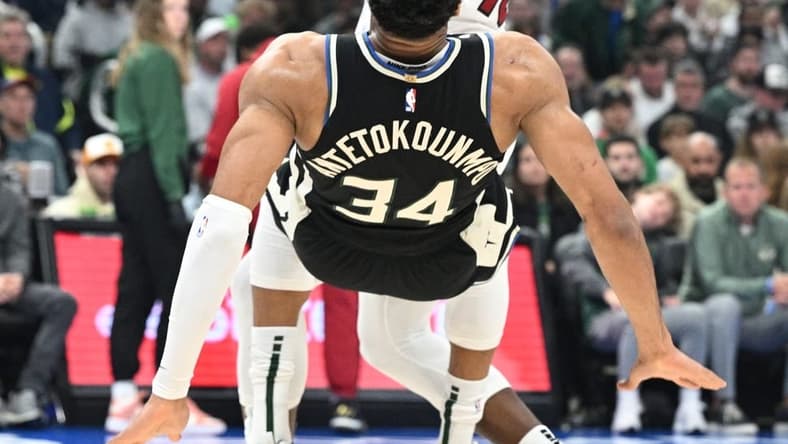 Apr 16, 2023; Milwaukee, Wisconsin, USA; Miami Heat center Bam Adebayo (13) drives against Milwaukee Bucks forward Giannis Antetokounmpo (34) in the first half during game one of the 2023 NBA Playoffs at Fiserv Forum. Mandatory Credit: Michael McLoone-USA TODAY Sports