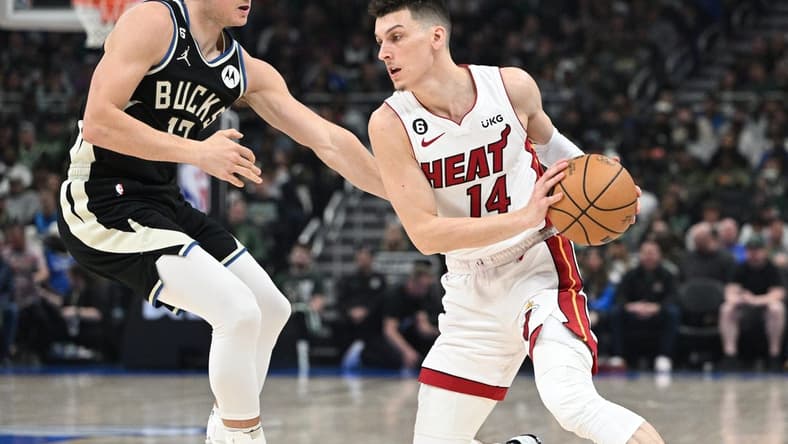 Apr 16, 2023; Milwaukee, Wisconsin, USA; Miami Heat guard Tyler Herro (14) drives against Milwaukee Bucks guard Jrue Holiday (21) in the first half during game one of the 2023 NBA Playoffs at Fiserv Forum. Mandatory Credit: Michael McLoone-USA TODAY Sports