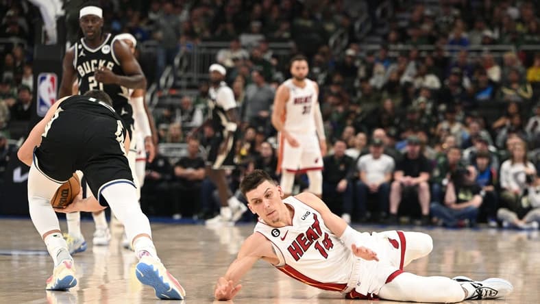 Apr 16, 2023; Milwaukee, Wisconsin, USA; Miami Heat guard Tyler Herro (14) injures his hand while diving for a loose ball against the Milwaukee Bucks during game one of the 2023 NBA Playoffs at Fiserv Forum. Mandatory Credit: Michael McLoone-USA TODAY Sports