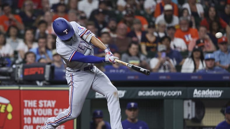 Apr 16, 2023; Houston, Texas, USA; Texas Rangers second baseman Marcus Semien (2) hits a grand slam during the seventh inning against the Houston Astros at Minute Maid Park. Mandatory Credit: Troy Taormina-USA TODAY Sports