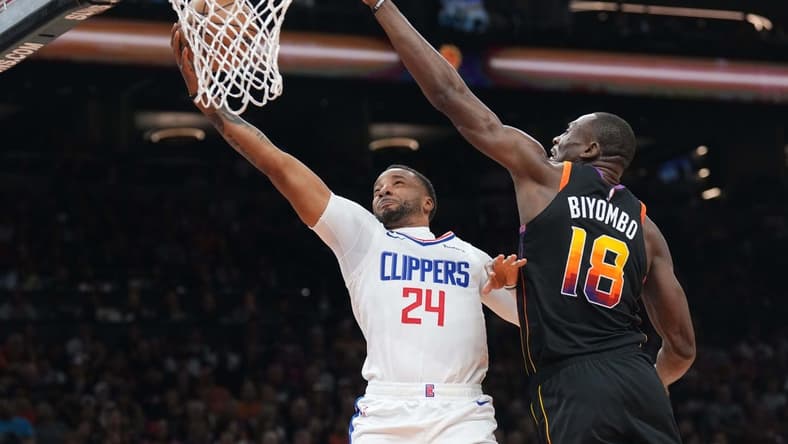 Apr 16, 2023; Phoenix, Arizona, USA; LA Clippers guard Norman Powell (24) puts up a layup against Phoenix Suns center Bismack Biyombo (18) during the first half of game one of the 2023 NBA playoffs at Footprint Center. Mandatory Credit: Joe Camporeale-USA TODAY Sports