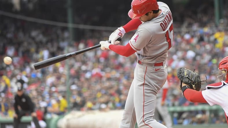 Apr 17, 2023; Boston, Massachusetts, USA;  Los Angeles Angels designated hitter Shohei Ohtani (17) hits a single during the first inning against the Boston Red Sox at Fenway Park. Mandatory Credit: Bob DeChiara-USA TODAY Sports