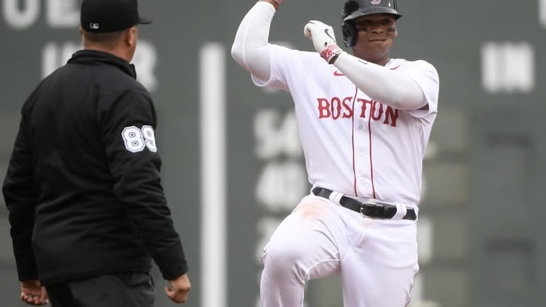 Apr 17, 2023; Boston, Massachusetts, USA;  Boston Red Sox third baseman Rafael Devers (11) reacts after hitting a double against the Los Angeles Angels during the fourth inning at Fenway Park. Mandatory Credit: Bob DeChiara-USA TODAY Sports